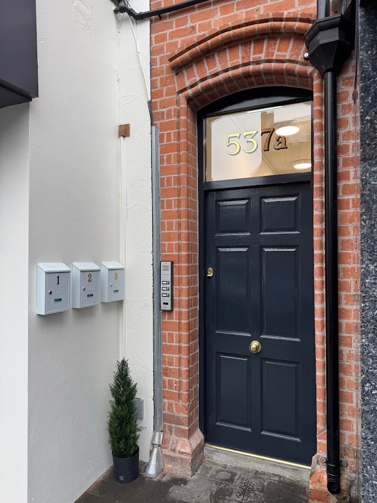 Close-up of a bespoke hand-painted house number gilded with 23.5ct Italian gold leaf on an Edwardian home in Belfast